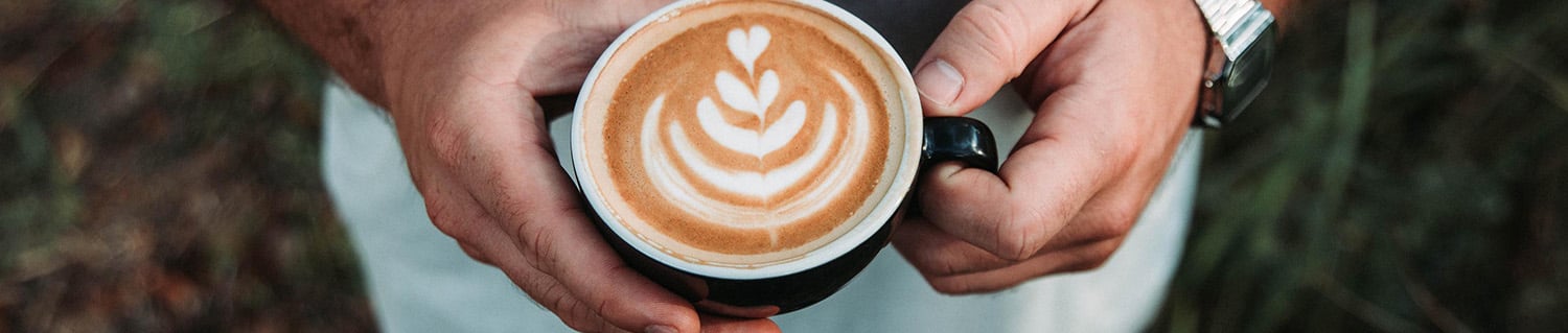 hands holding a cup of coffee