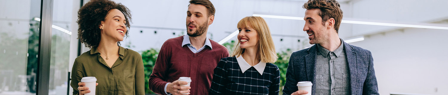 a group of business people walking side by side smiling and talking to each other