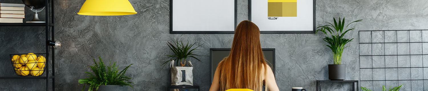 back of a woman sitting in front of a computer